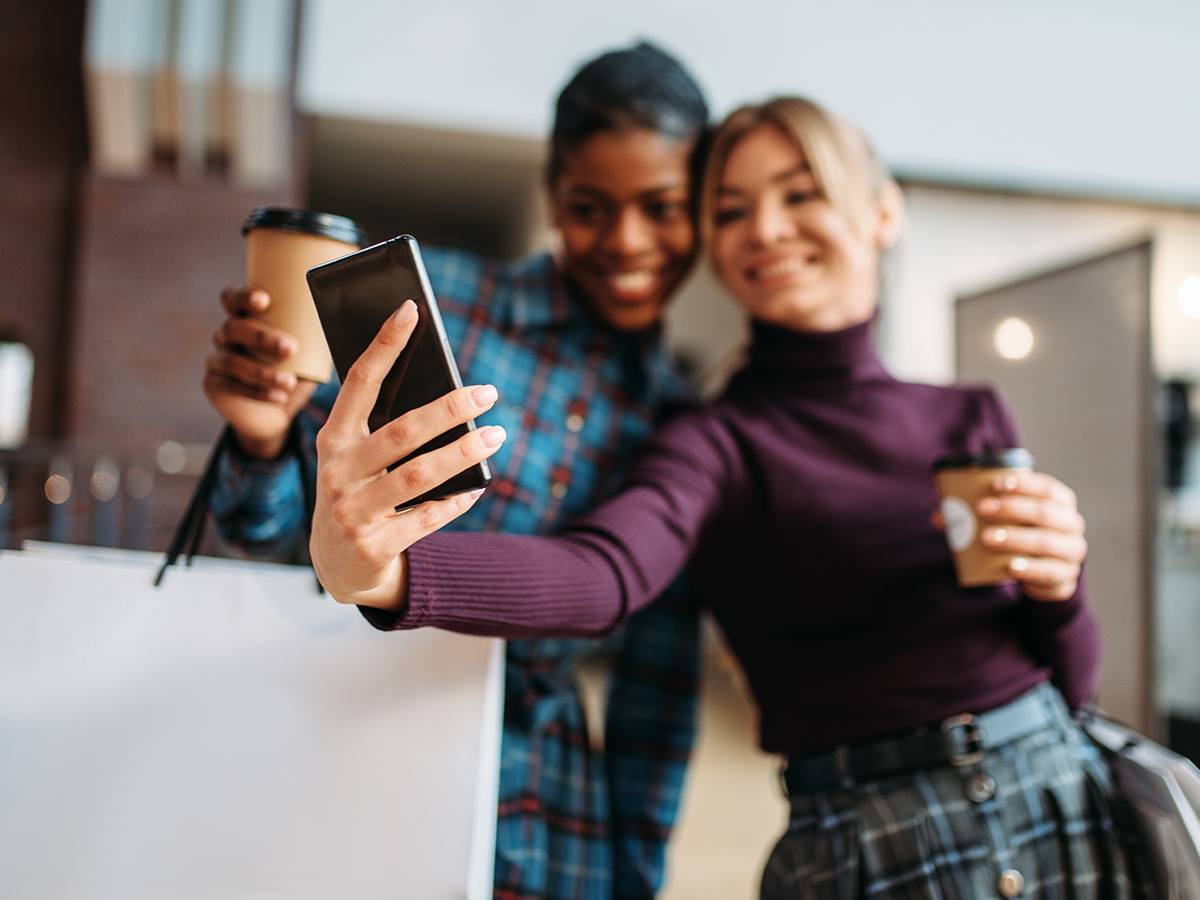 Two customers taking selfies